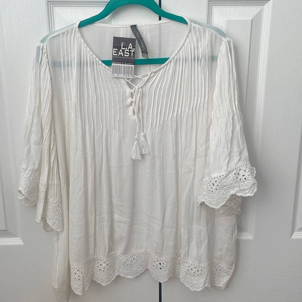 Flowing cream white top.